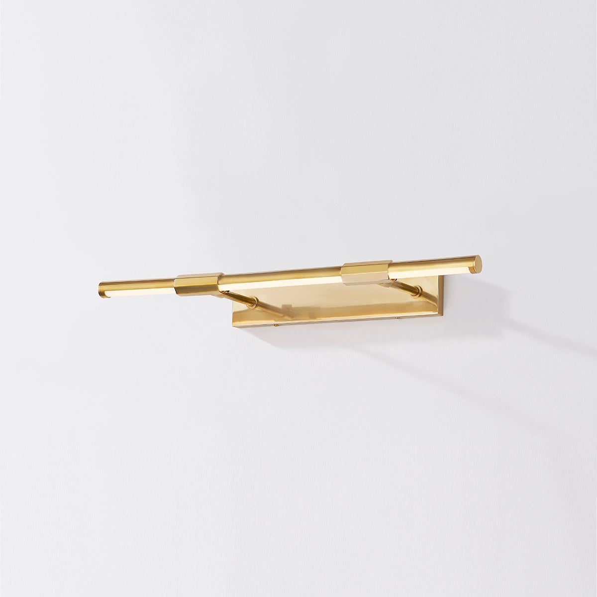 Close-up of the Melbourne Picture Light 23.75" in aged brass showing the arm curve and shade proportion.