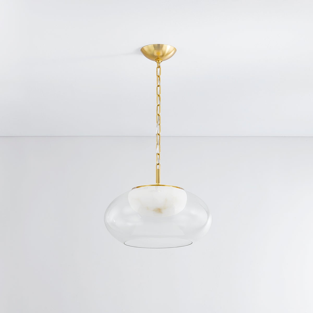 Moore Pendant 17" in aged brass shown from the front to reveal the shade shape and metal detail.
