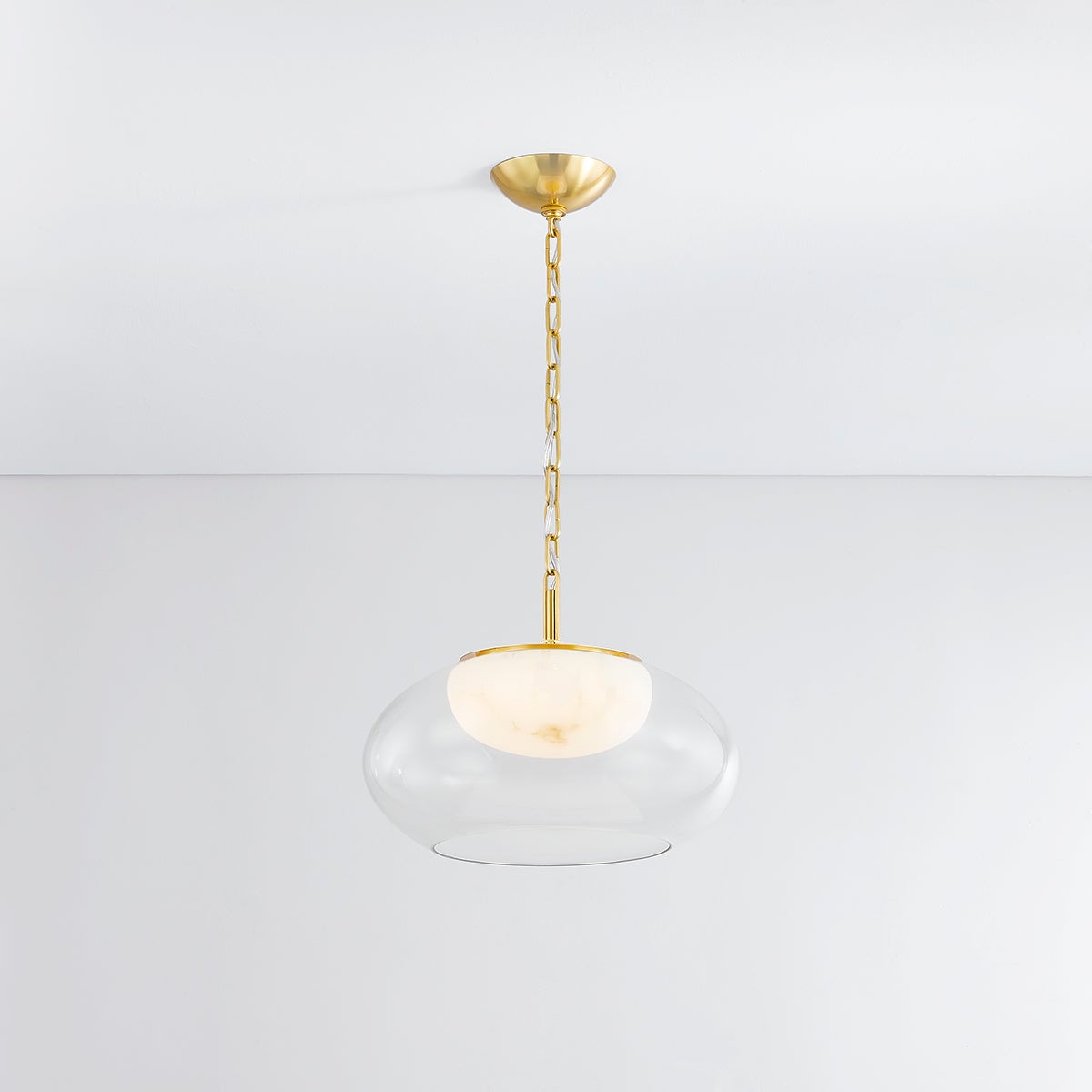 Close-up of the Moore Pendant 17" in aged brass showing the shade shape and metal detail.