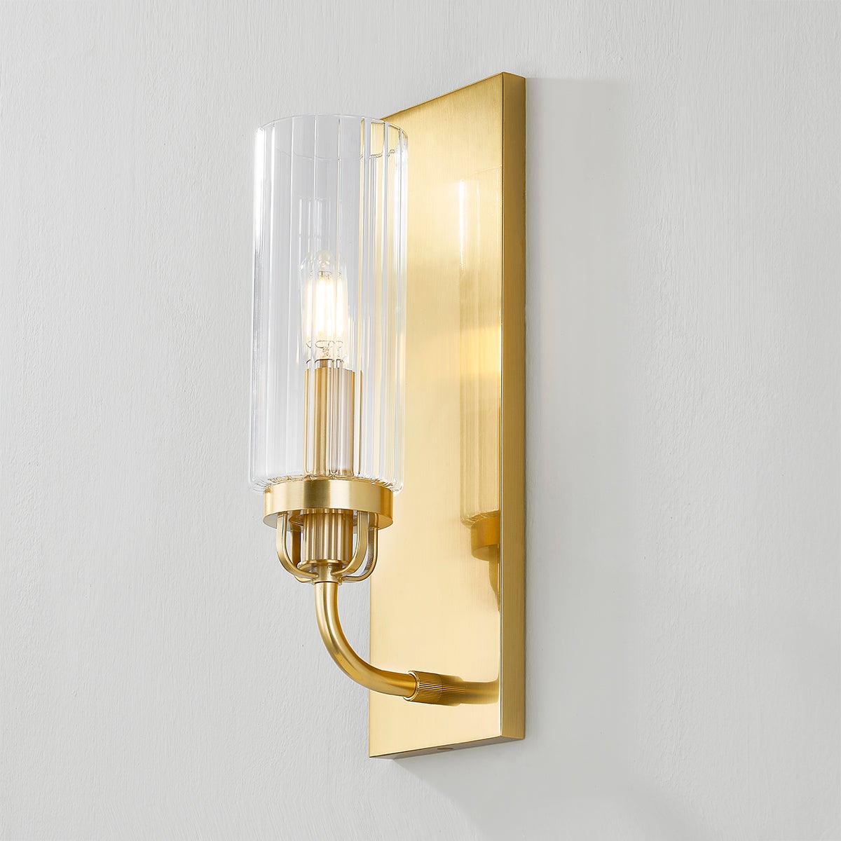 Halifax Wall Sconce in aged brass shown from the front to reveal the arm curve and shade silhouette.