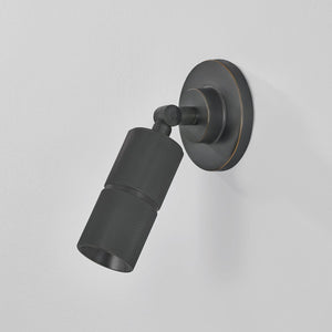 Close-up of the Truett Wall Sconce in dark bronze showing the arm curve and shade silhouette.
