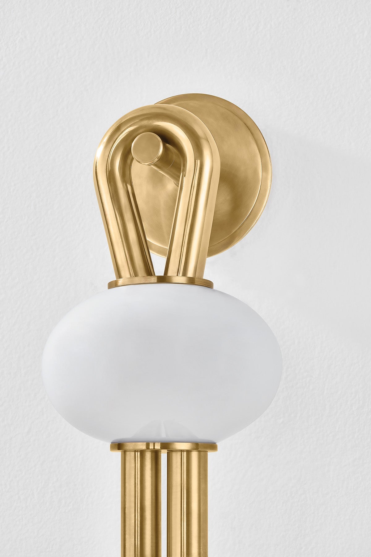 Ala Wall Sconce shown from the front to reveal the arm curve and shade silhouette.