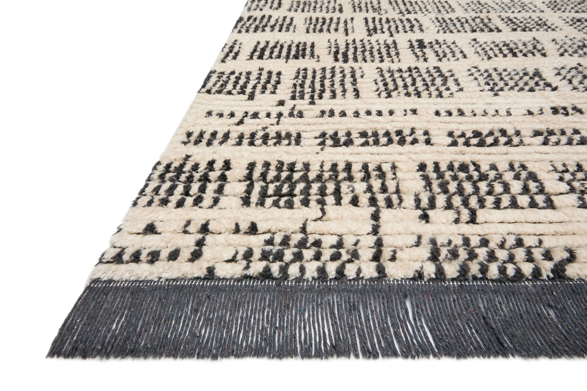 Side view of the Alice Cream / Charcoal by Chris Loves Julia x Loloi (Pattern 2) rug.
