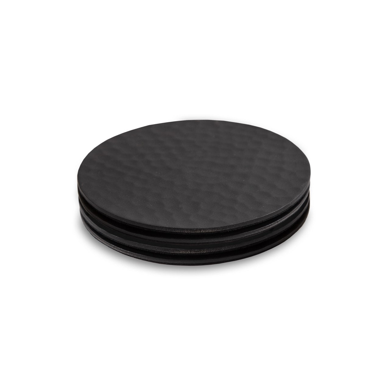 Four black round coasters with a textured surface on a white background