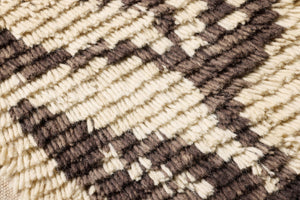 Nature's Unfurling Dark Brown Rug Art shown from a different angle to reveal its pattern.