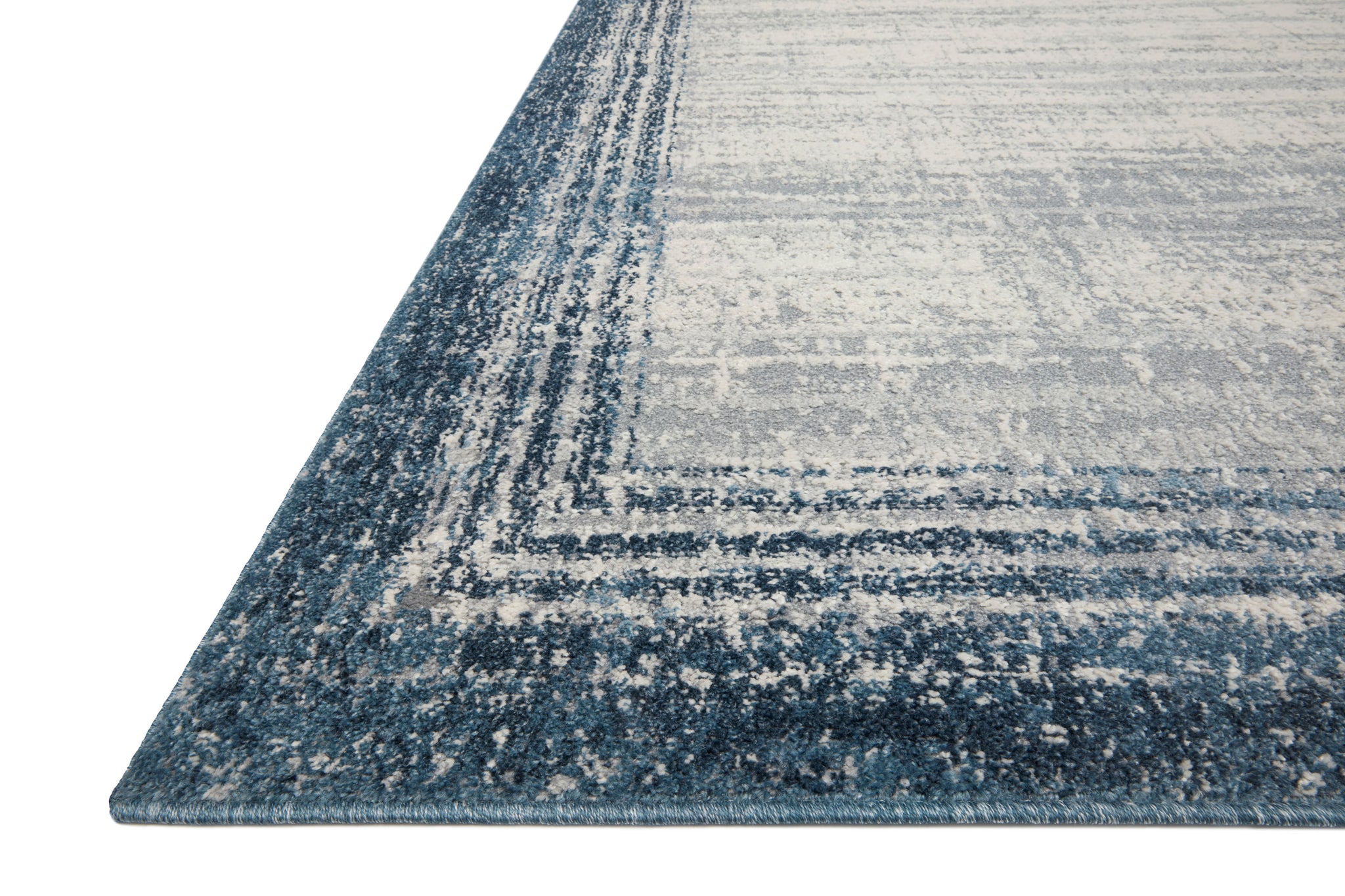 Side view of the Austen Pebble / Blue rug.