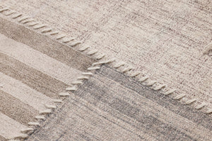 Pieced Work Beige / Brown Rug Art shown from another angle.