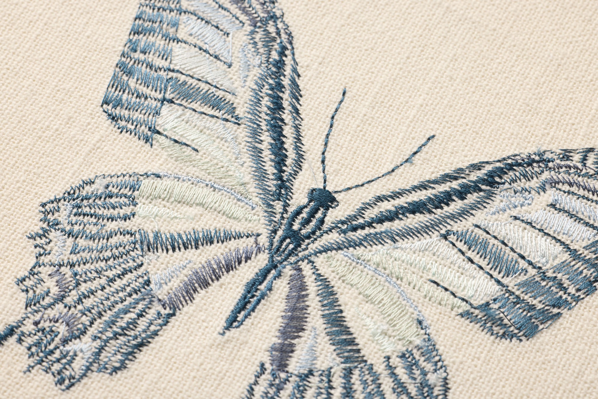Butterfly Blue Ivory / Blue Rug Art shown from a different angle to reveal its pattern.