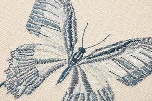 Butterfly Blue Ivory / Blue Rug Art shown from a different angle to reveal its pattern.