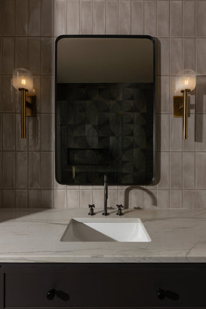 Axton Wall Sconce styled in a curated living room for warm, layered light at Laurie Yapp Home.