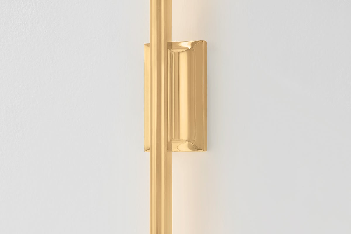Close-up of the Bernard Wall Sconce in aged brass showing the arm curve and shade silhouette.