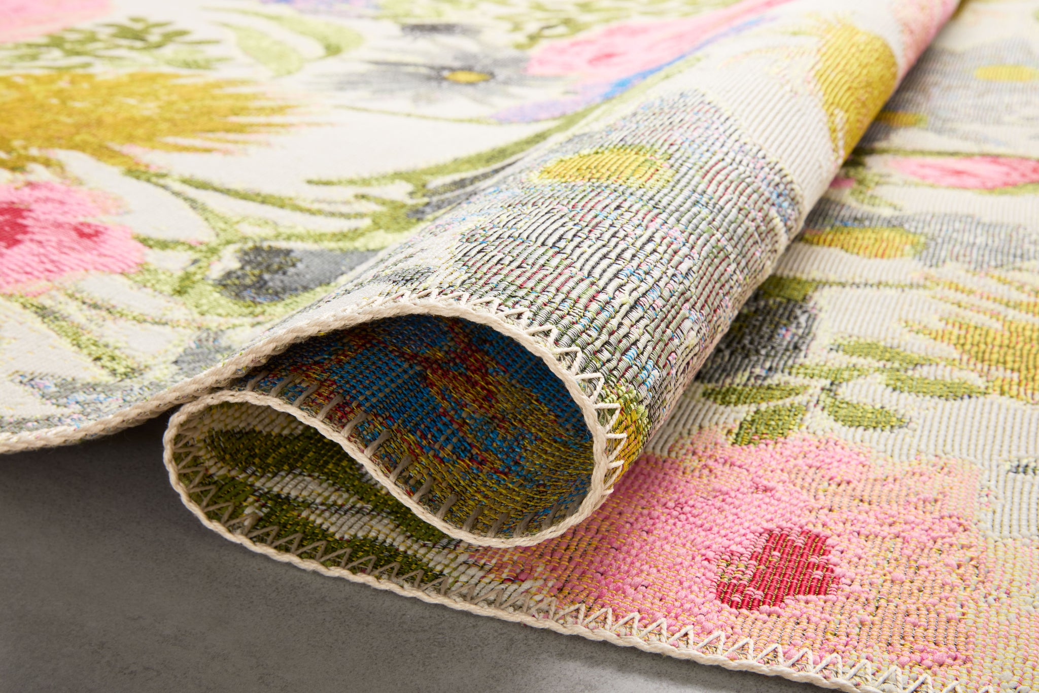 Close-up detail of the Botanical Ivory / Multi showing its pile and weave.