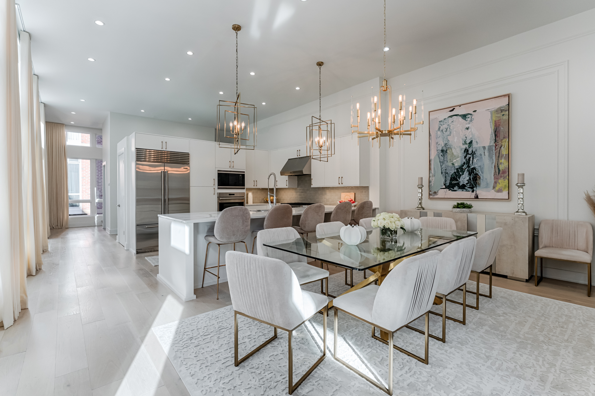 Bari Chandelier 30" in aged brass styled in a two-story entry for warm, layered light at Laurie Yapp Home.