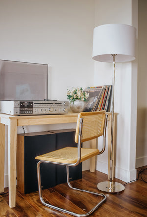 Bowery Floor Lamp in polished nickel styled in a living room corner for warm, layered light at Laurie Yapp Home.