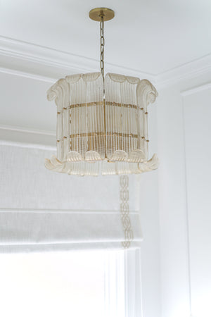 Brasher Chandelier in aged brass styled in an elegant dining room for warm, layered light at Laurie Yapp Home.