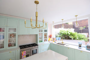 Ivy Pendant 7.5" in aged brass styled in a welcoming entryway for warm, layered light at Laurie Yapp Home.