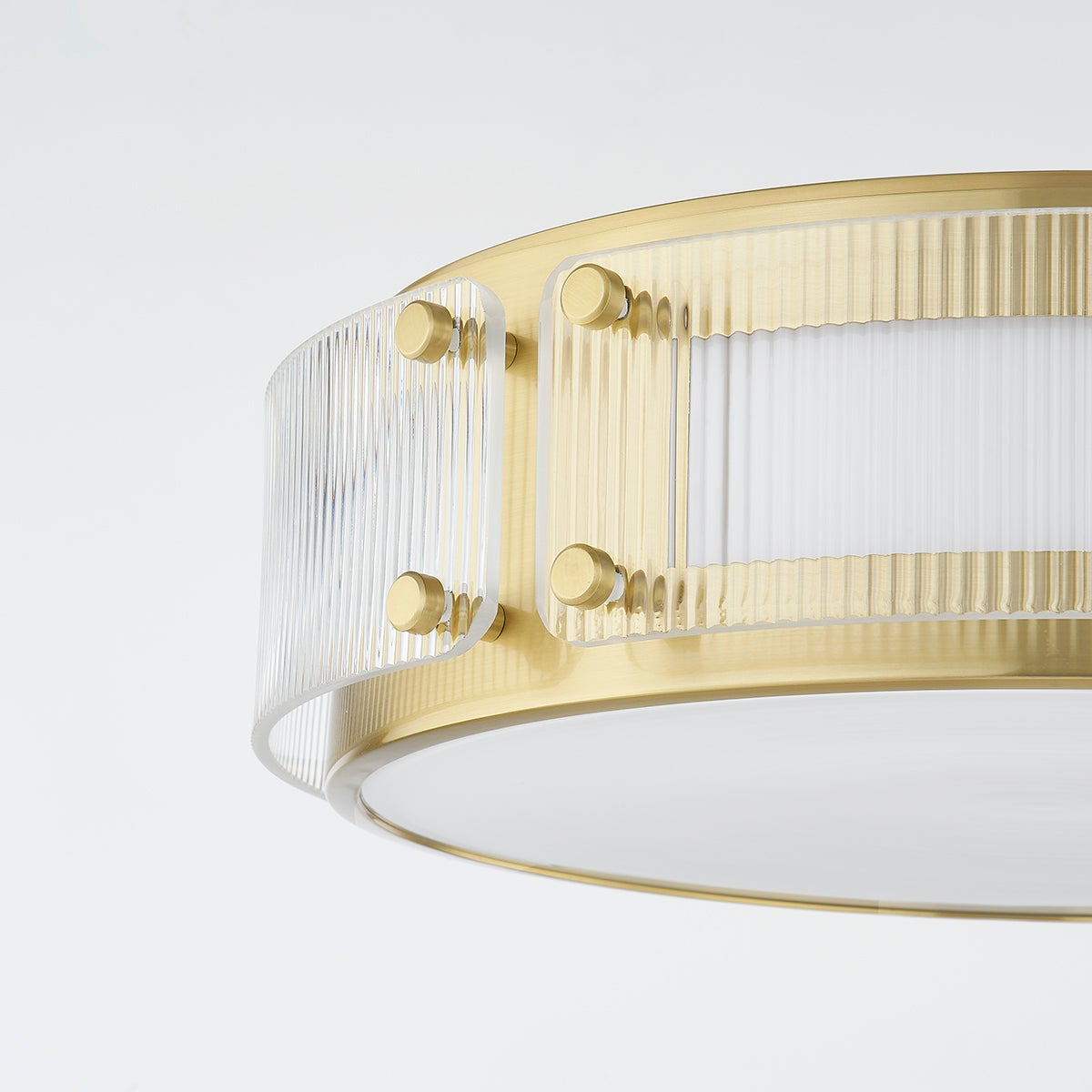 Close-up of the Clifford Flush Mount in aged brass showing the shade profile and mounting canopy.