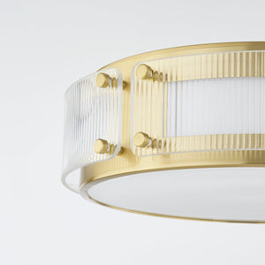 Close-up of the Clifford Flush Mount in aged brass showing the shade profile and mounting canopy.