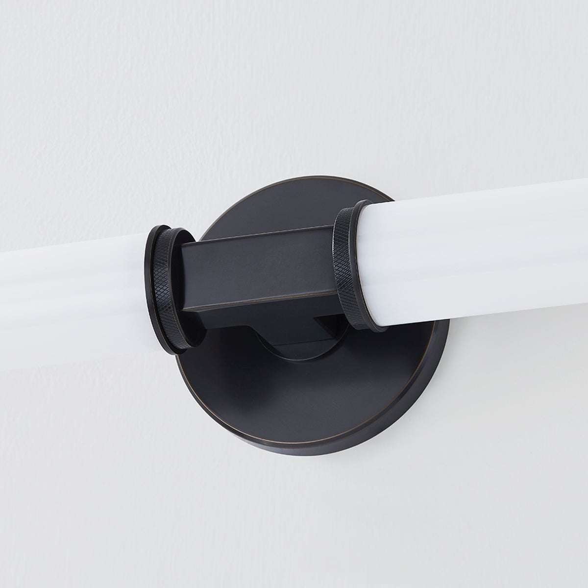 Close-up of the Cromwell Wall Sconce 4.75" x 22.75" in bronze showing the arm curve and shade silhouette.