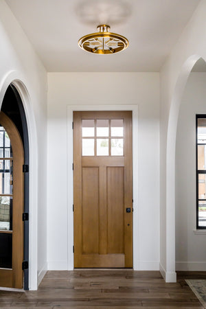 Chambers Semi Flush in aged brass styled in an entryway for warm, layered light at Laurie Yapp Home.