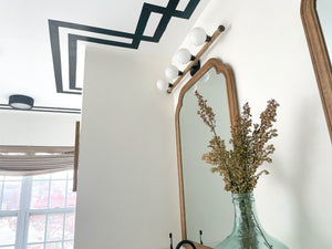 Crispin Flush Mount 9.5" in bronze styled in a bedroom for warm, layered light at Laurie Yapp Home.
