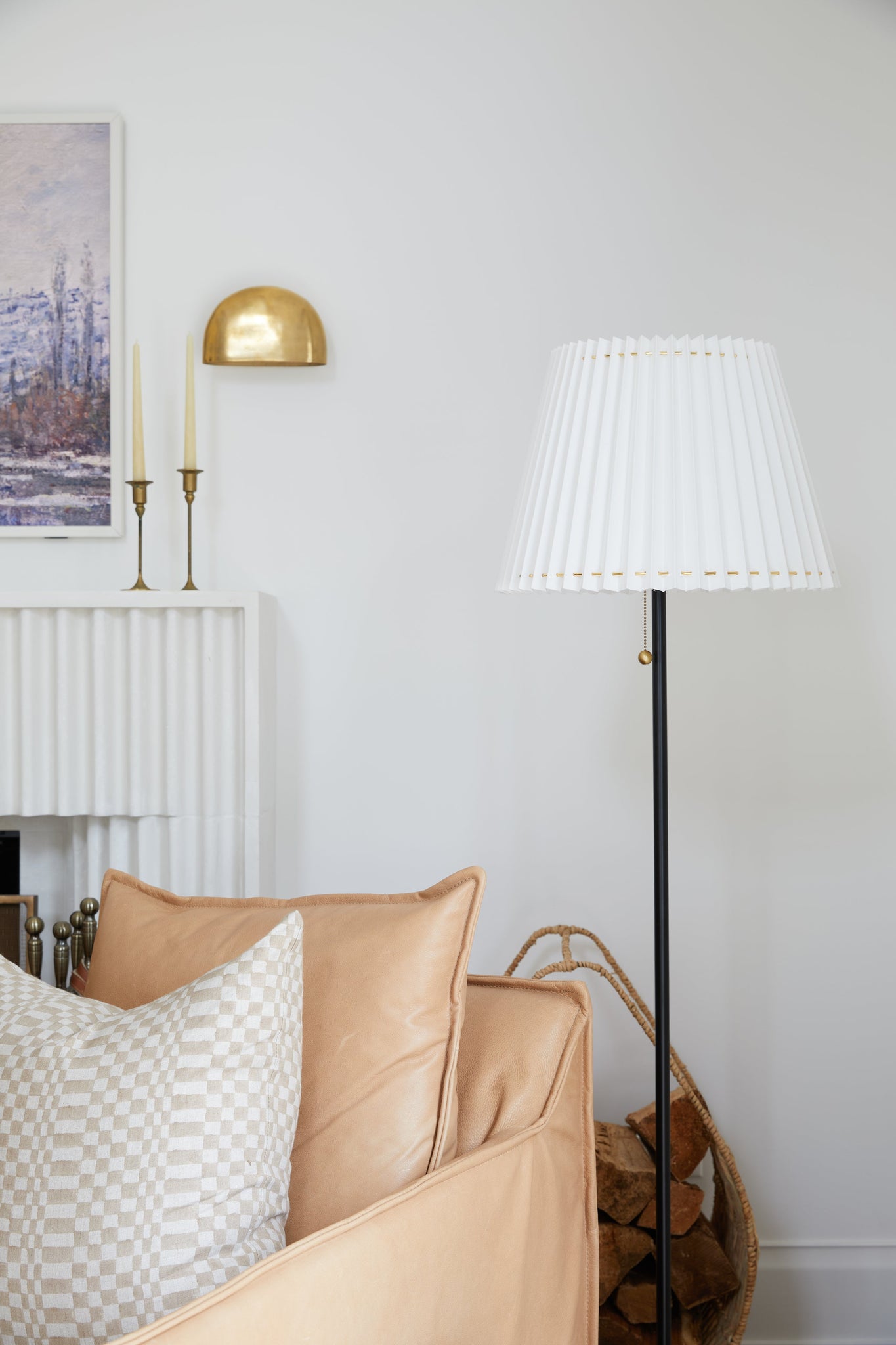 Diggs Wall Sconce in aged brass styled in a modern bathroom for warm, layered light at Laurie Yapp Home.