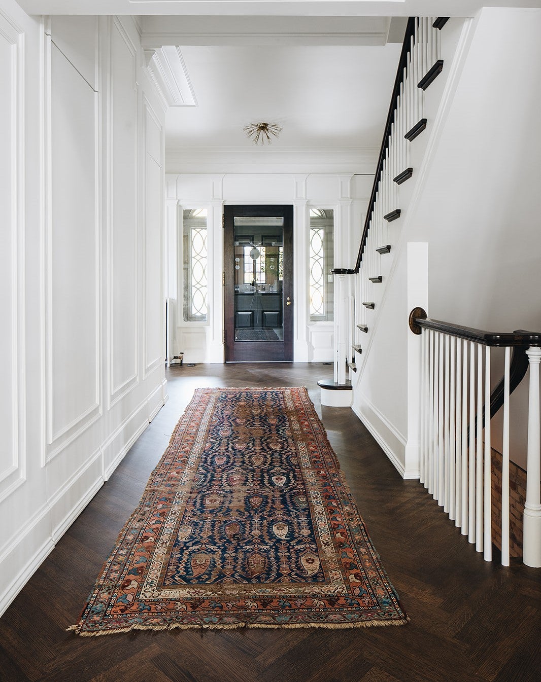 Dunkirk Semi Flush 20" in aged brass styled in an entryway for warm, layered light at Laurie Yapp Home.