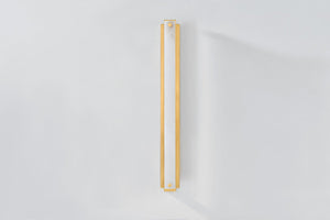 Edgemere Wall Sconce in aged brass shown from the front to reveal the arm curve and shade silhouette.