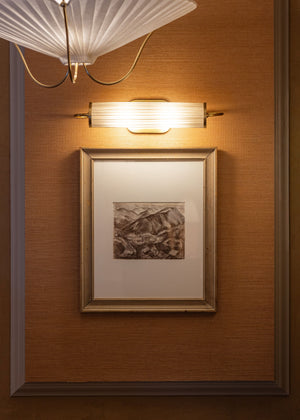 Close-up of the Elaine Picture Light in aged brass showing the arm curve and shade proportion.