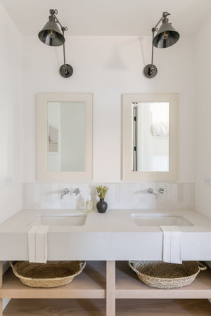 Garden City Wall Sconce 8" x 23" in bronze styled in a curated living room for warm, layered light at Laurie Yapp Home.