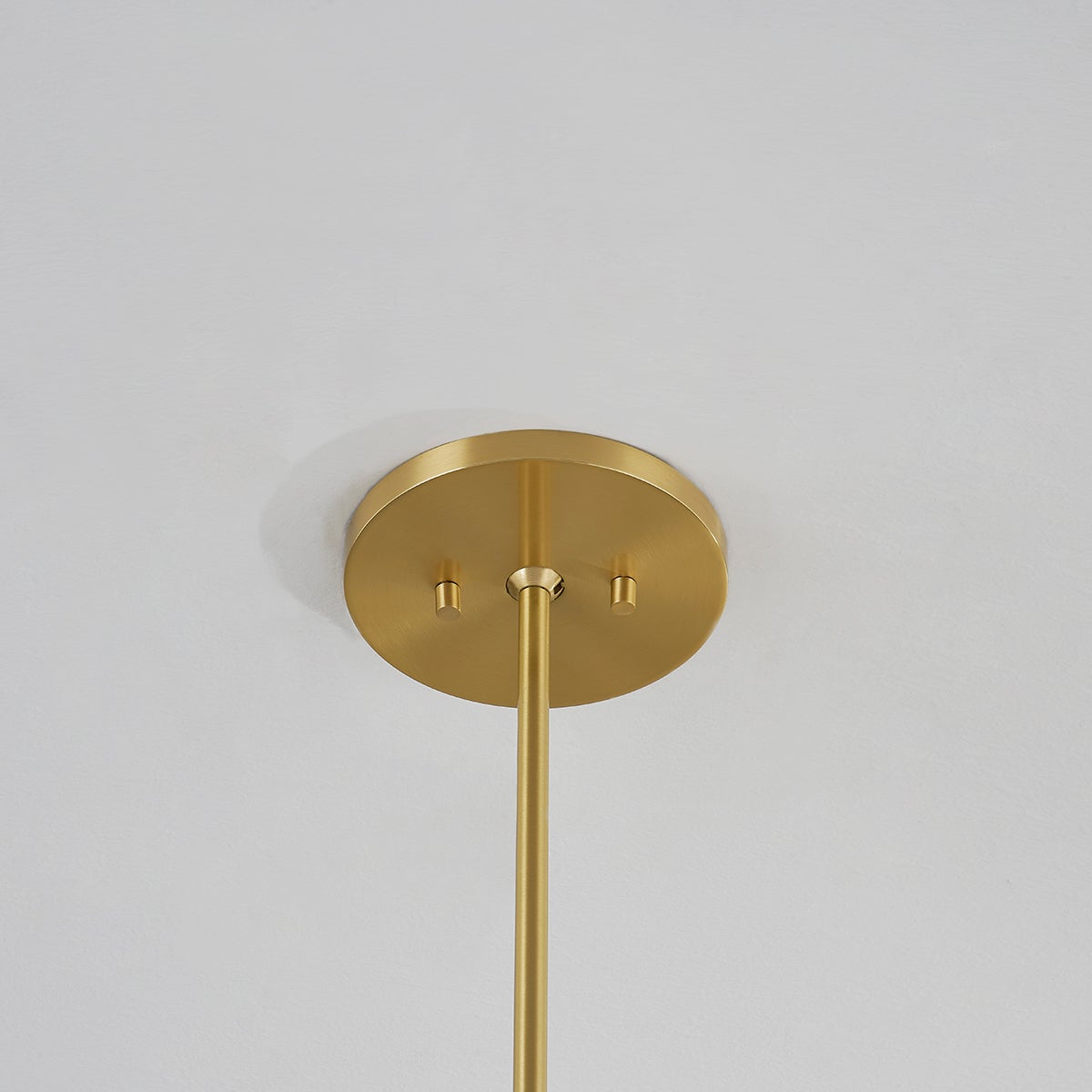 Glenmoore Pendant in aged brass shown from a second angle to highlight the shade shape and metal detail.