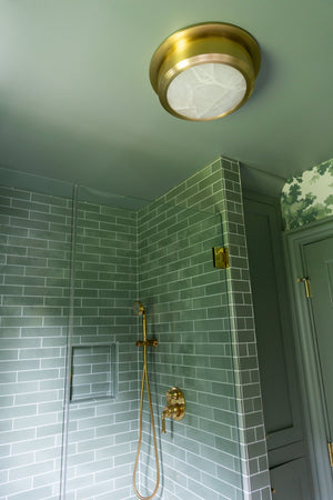 Greenport Flush Mount 14" in aged brass styled in a hallway for warm, layered light at Laurie Yapp Home.