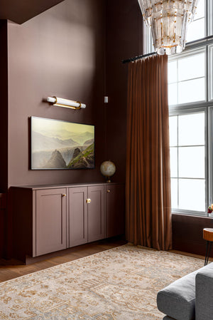 Groveland Station Wall Sconce 4.75" x 27.75" in aged brass styled in a modern bathroom for warm, layered light at Laurie Yapp Home.