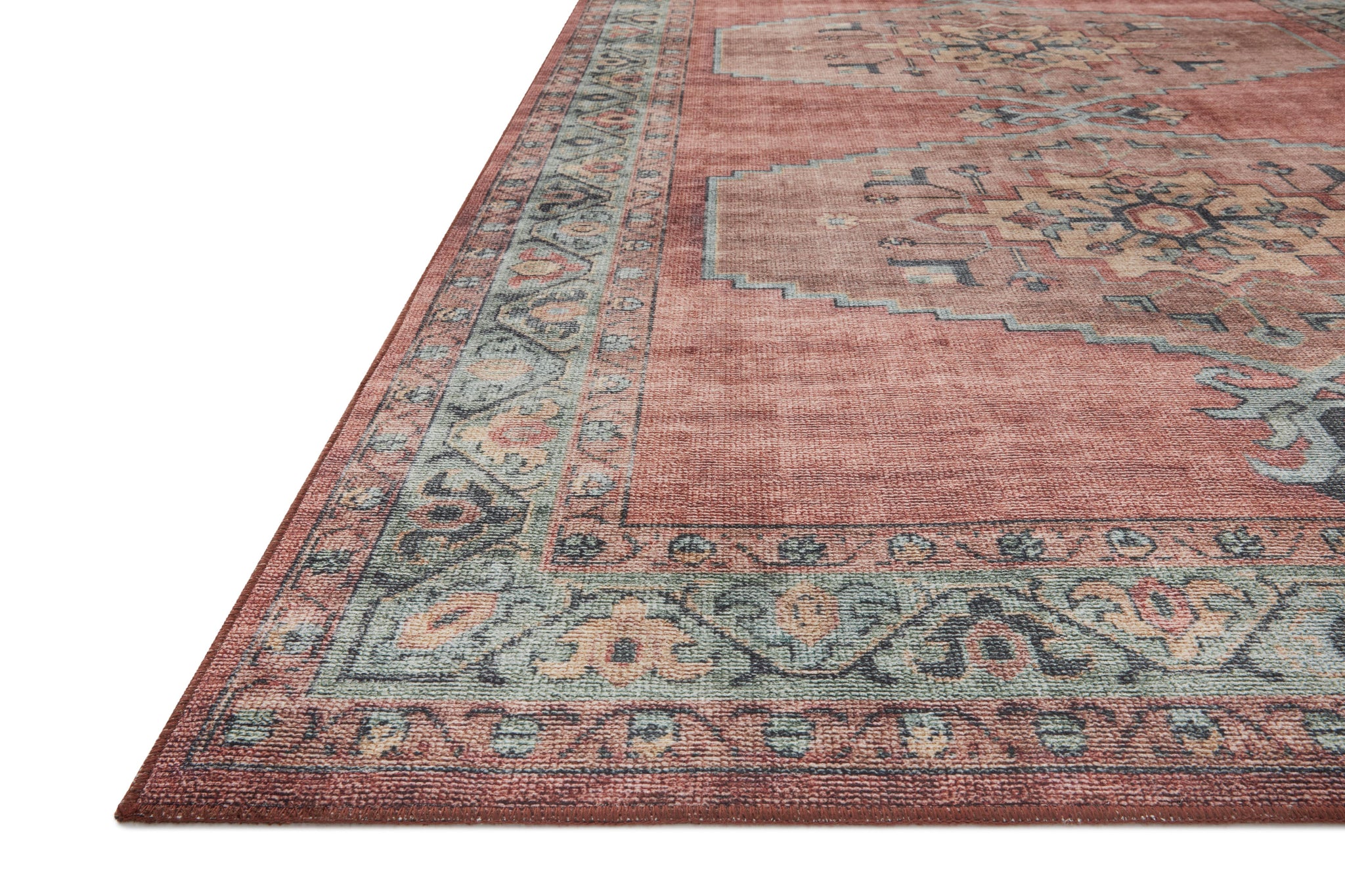 Side view of the Heidi Spice / Aqua rug.