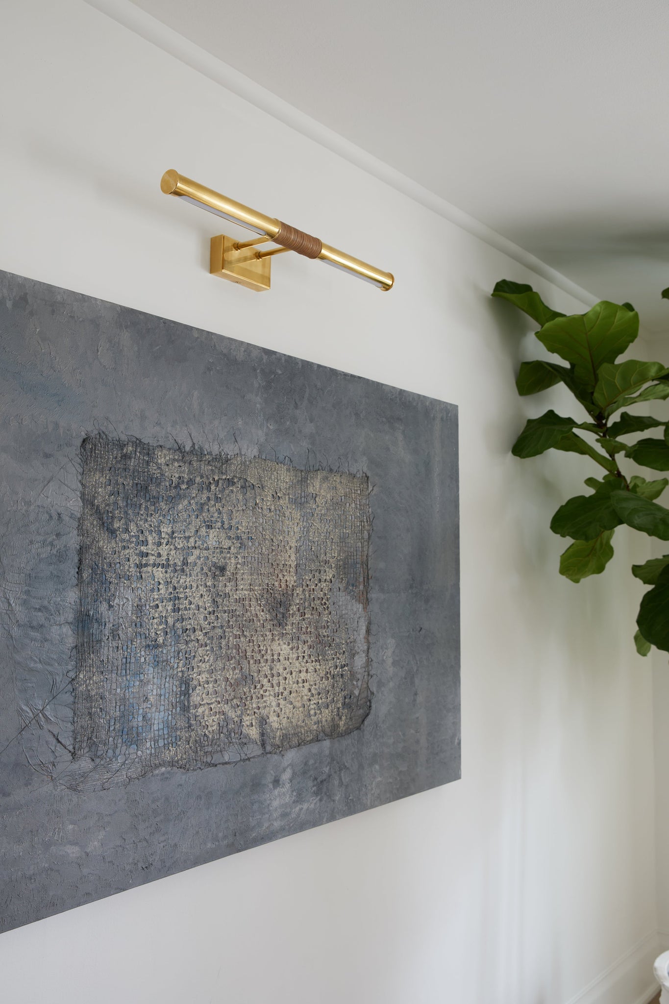 Hallstead Picture Light 24" in aged brass styled in a reading room for warm, layered light at Laurie Yapp Home.