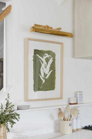 Hampshire Picture Light 23.25" in aged brass styled in a gallery wall for warm, layered light at Laurie Yapp Home.