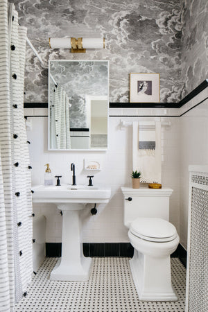 Harper Bath And Vanity in aged brass styled in a primary ensuite for warm, layered light at Laurie Yapp Home.