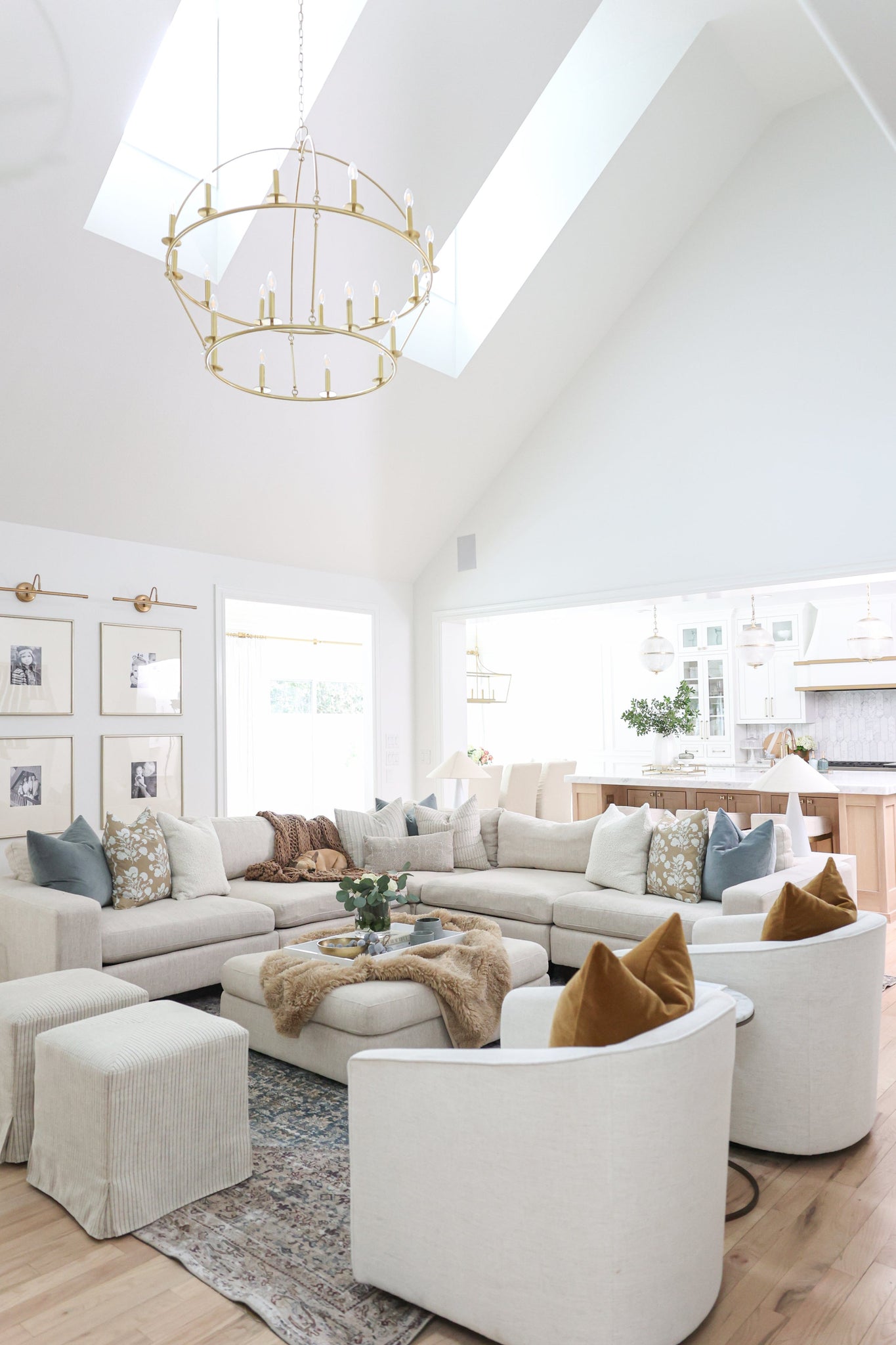 Howell Chandelier 47" x 42.25" in aged brass styled in a two-story entry for warm, layered light at Laurie Yapp Home.