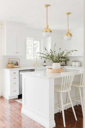 Lambert Pendant 9.5" in aged brass styled in a welcoming entryway for warm, layered light at Laurie Yapp Home.