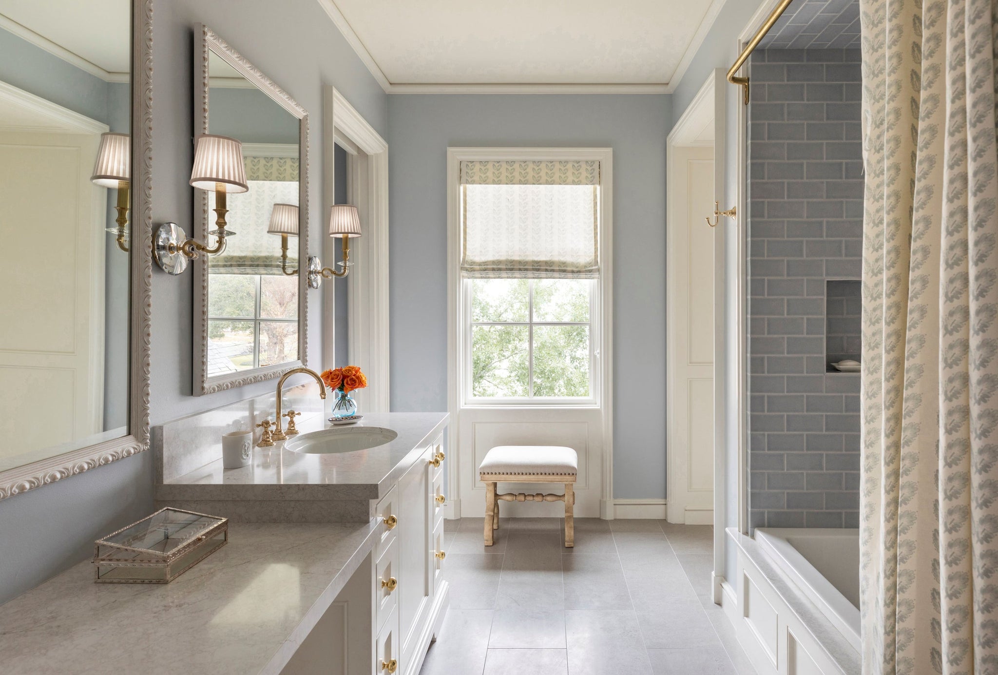 Lapeer Wall Sconce in aged brass styled in a curated living room for warm, layered light at Laurie Yapp Home.