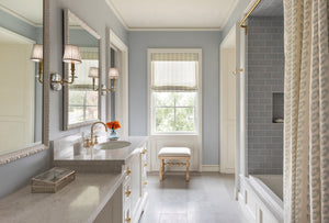 Lapeer Wall Sconce in aged brass styled in a curated living room for warm, layered light at Laurie Yapp Home.