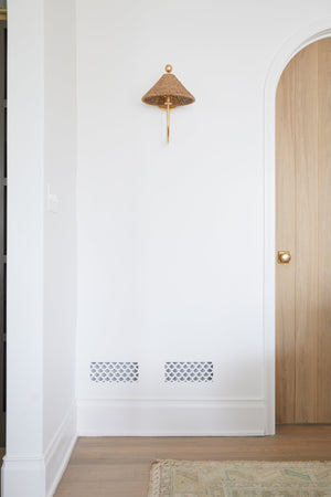 Layton Wall Sconce styled in a warmly lit hallway for warm, layered light at Laurie Yapp Home.
