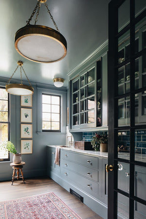 Lynden Chandelier 22" in aged brass styled in a two-story entry for warm, layered light at Laurie Yapp Home.