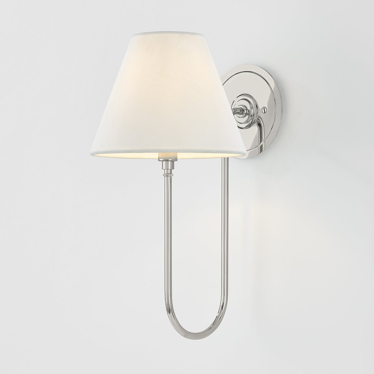 Close-up of the Hawthorne Wall Sconce in polished nickel showing the arm curve and shade silhouette.