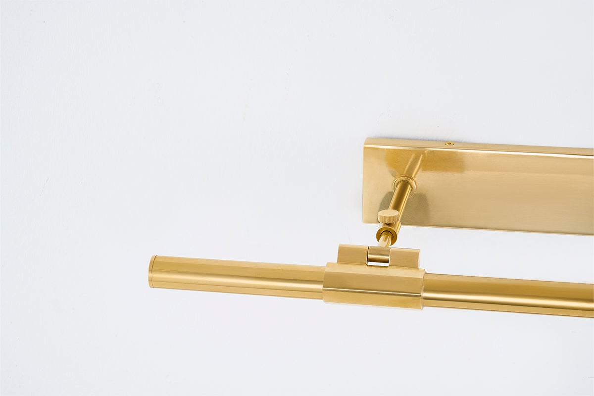 Close-up of the Melbourne Picture Light 23.75" in aged brass showing the arm curve and shade proportion.