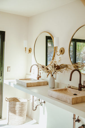 Mason Wall Sconce in aged brass shown from the front to reveal the arm curve and shade silhouette.