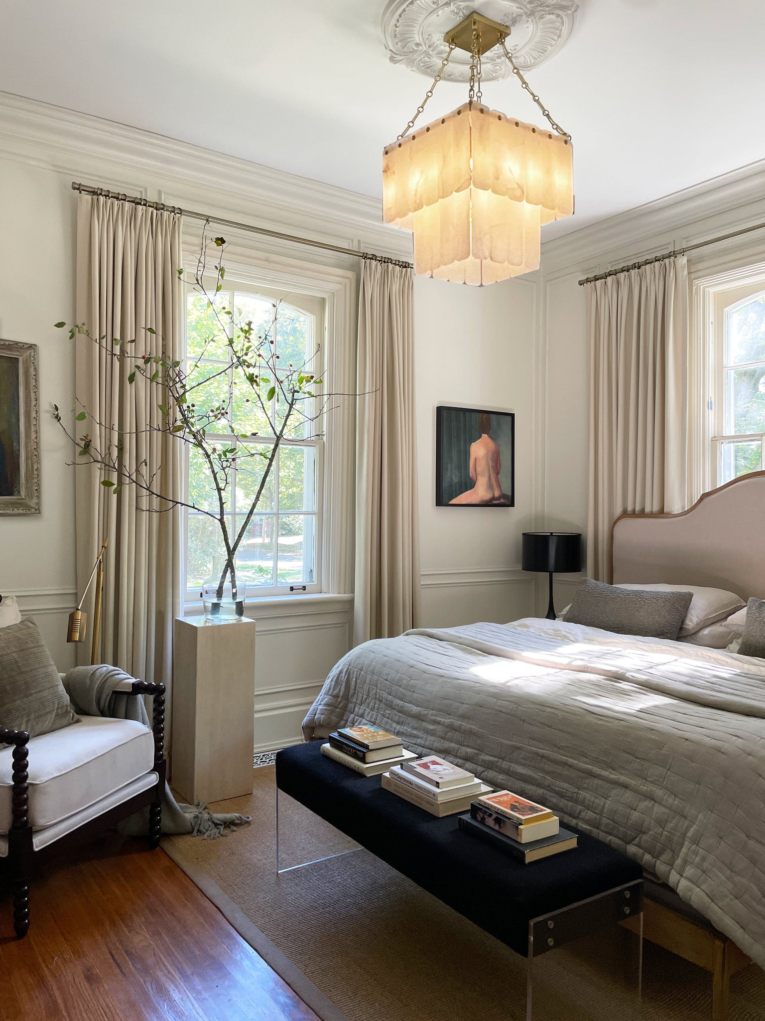 Moissanite Chandelier 20" in aged brass styled in an elegant dining room for warm, layered light at Laurie Yapp Home.