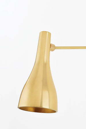 Close-up of the Northford Wall Sconce in aged brass showing the arm curve and shade silhouette.