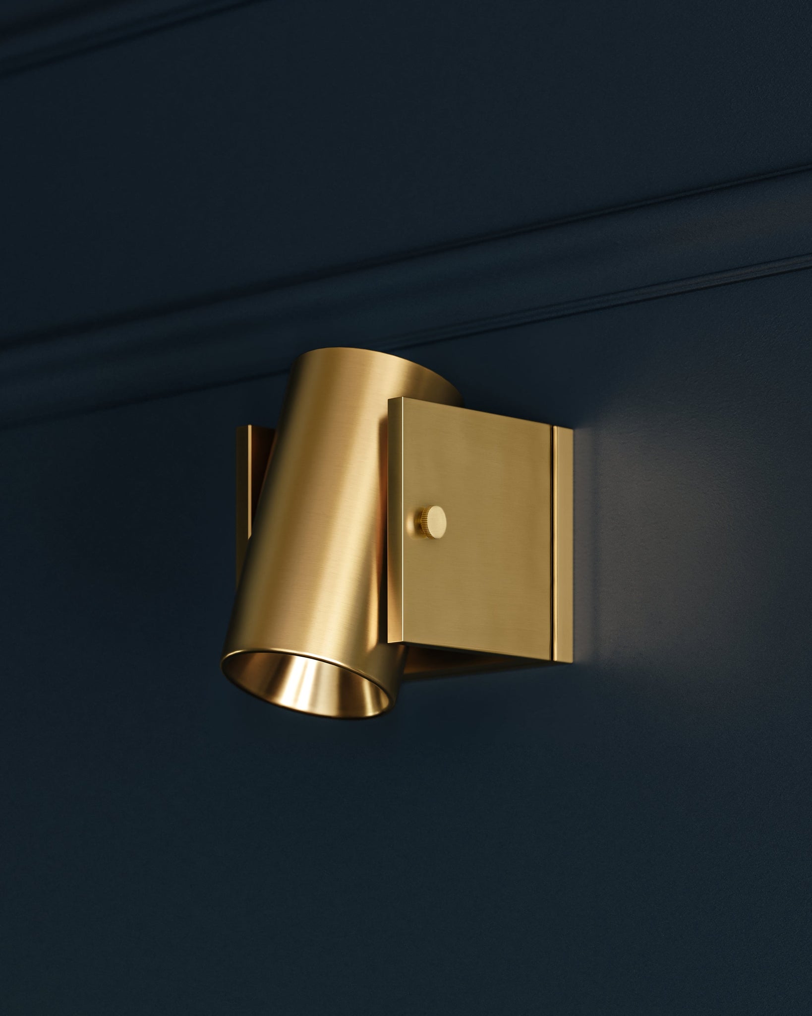 Close-up of the Nowra Wall Sconce in Aged Brass showing the arm curve and shade silhouette.
