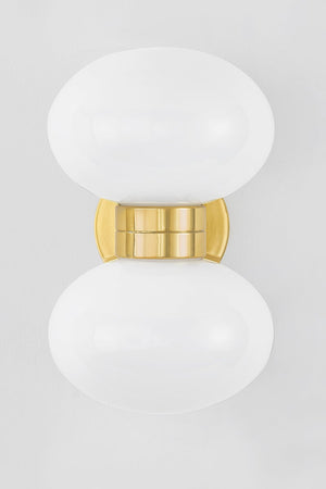 Otsego Wall Sconce in aged brass shown from the front to reveal the arm curve and shade silhouette.